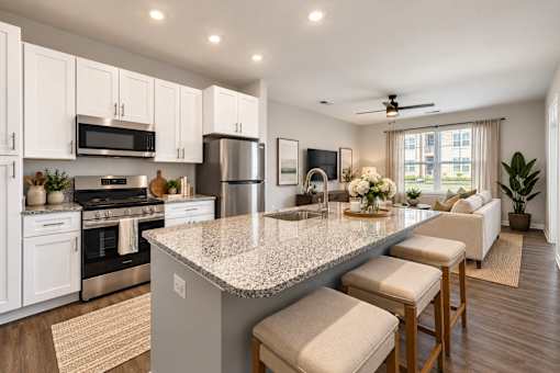 A kitchen with a granite countertop and white cabinets.