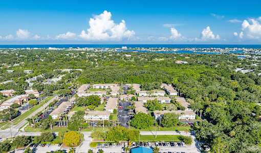 A bird's eye view of a residential area with a swimming pool.