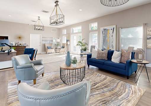 A living room with a blue couch and a grey armchairl at Fountains of Largo, Largo, 33774