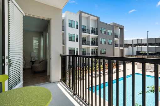 A modern apartment complex with a pool.