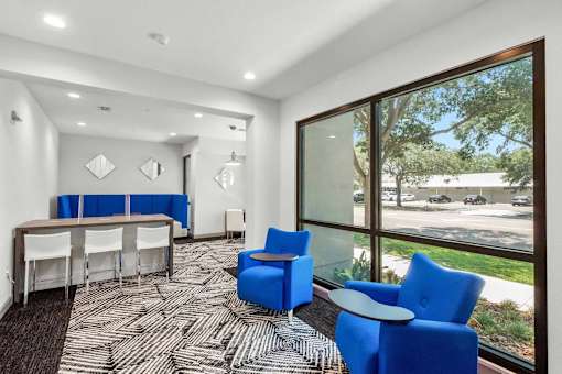 A conference room with a long table and chairs.