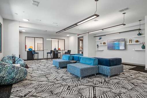 A modern living room with a black and white patterned carpet.