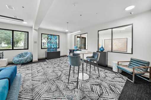 A modern living room with a black and white patterned carpet.