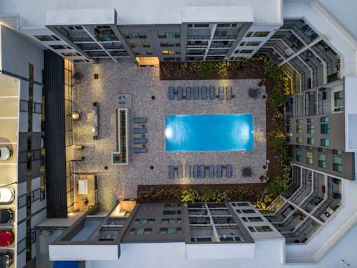 A modern house with a pool in the middle.