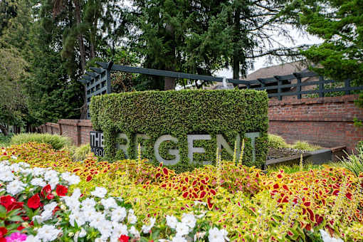 A garden with a sign that says "The Regent".