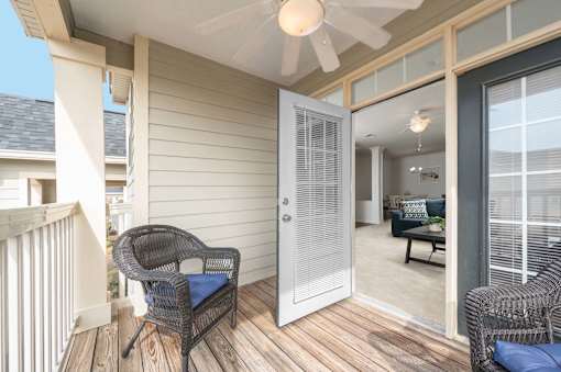 A patio with a chair and a table.