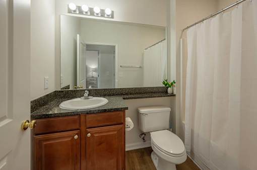 A bathroom with a sink, toilet, and shower.
