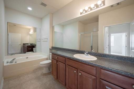 A bathroom with a sink, toilet, and bathtub.