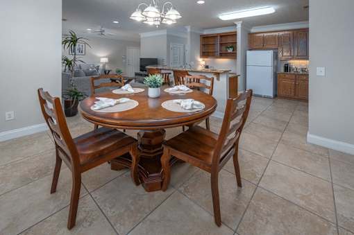 A dining room with a table set for four.