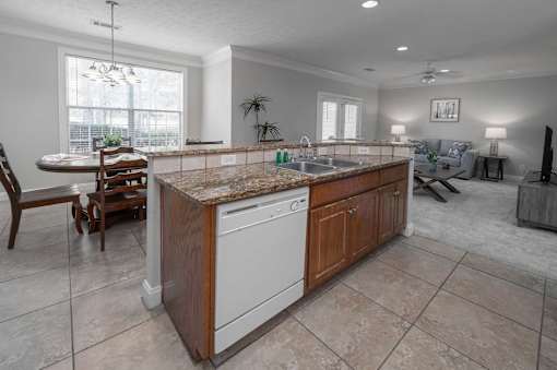 A kitchen with a granite countertop and a dishwasher.