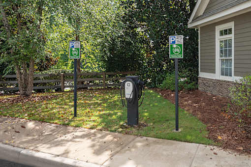 Two parking signs are on posts next to a parking meter.