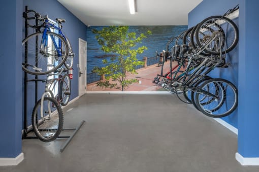 a room with a row of bikes hanging on the wall
