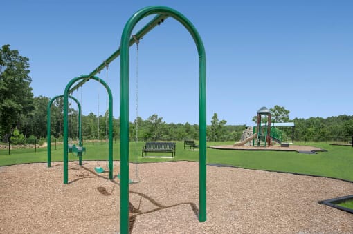 a playground at a park with a swing set