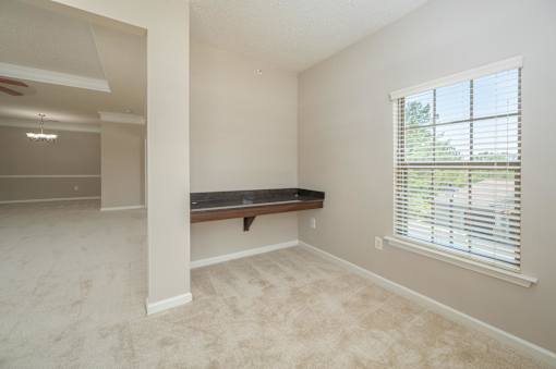 A room with a window and a bench.