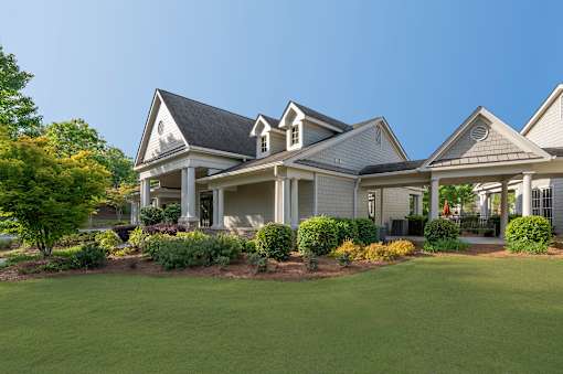 A large, well-maintained house with a front yard and landscaping.