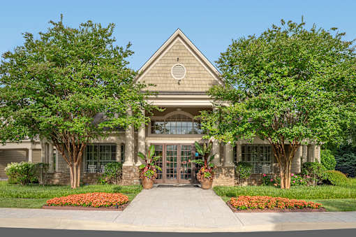 A building with a triangular roof and a circular logo on it.