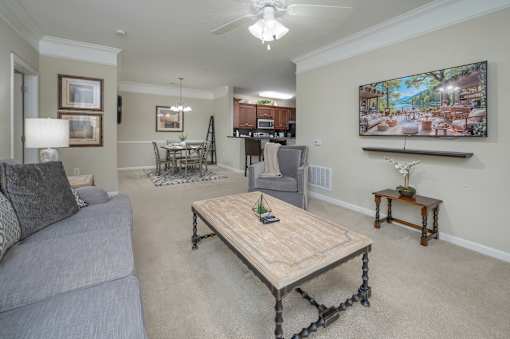 A living room with a grey couch and a wooden coffee table.