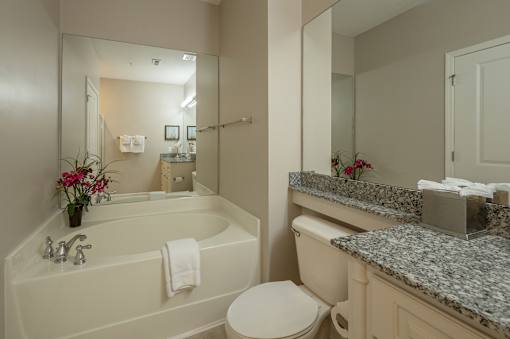 A white bathroom with a tub, toilet, and sink.