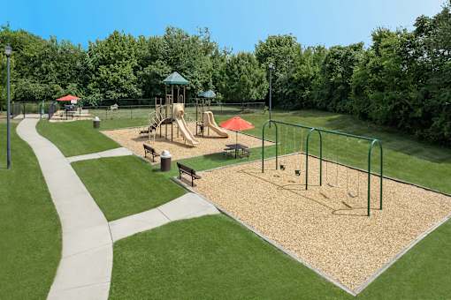 A playground with a slide, swings, and a sandbox.