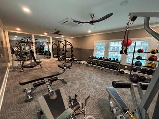 A spacious home gym with a variety of equipment.
