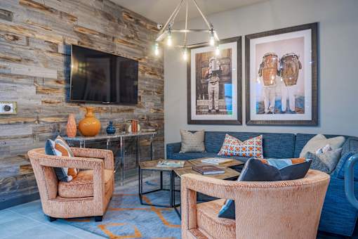 A living room with a stone wall and a blue couch.