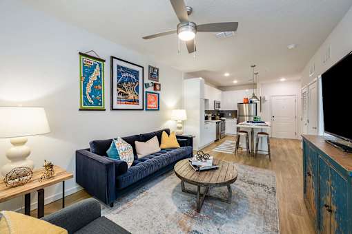 A living room with a blue couch and a coffee table.