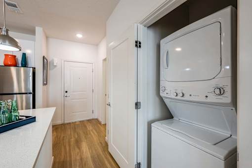 A white dryer is sitting in a small laundry room.