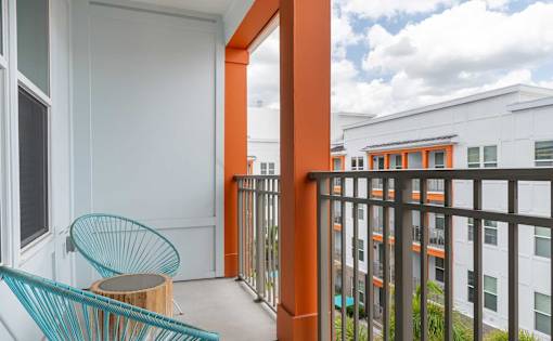 A balcony with a chair and table.