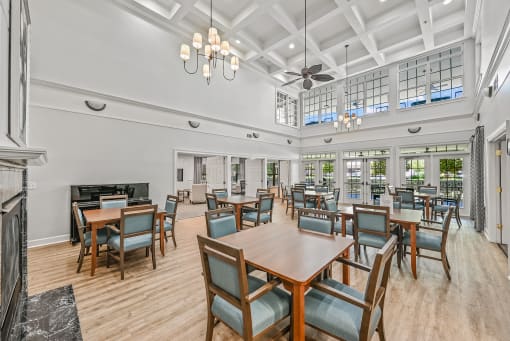 a large dining room with tables and chairs and a fireplace