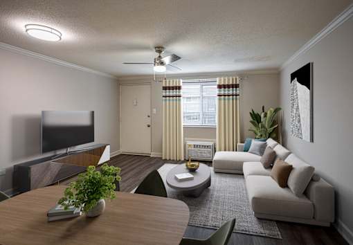 A modern living room with a flat screen TV, a sofa, a coffee table, and a potted plant.