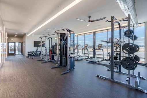 Townhomes in Bozeman, MT, with In-Unit Washer and Dryer - Highmark Bozeman - Fitness Center With Treadmills, Weight Machines, Free Weights, Floor To Ceiling Windows, And Mountain Views.