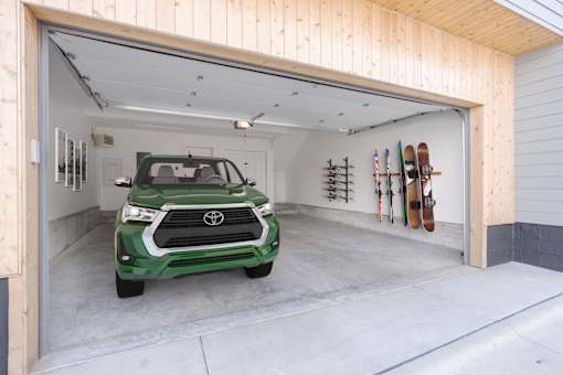 A green Toyota SUV is parked in a garage.
