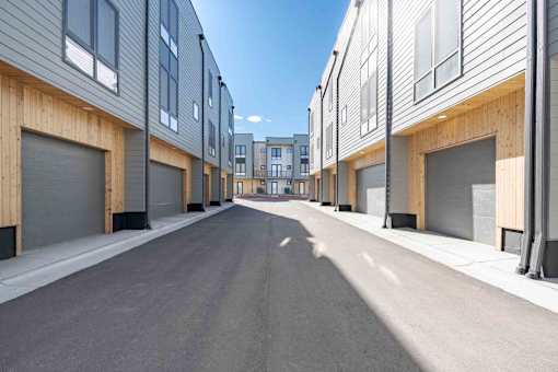 A long street with apartment buildings on both sides.