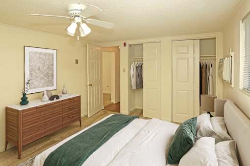 A bedroom with a bed, dresser, and closet.