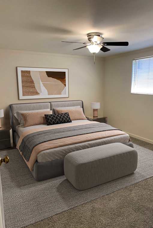 A bedroom with a bed, pillows, a ceiling fan, and a painting on the wall.