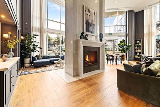 A modern living room with a fireplace and a large window.