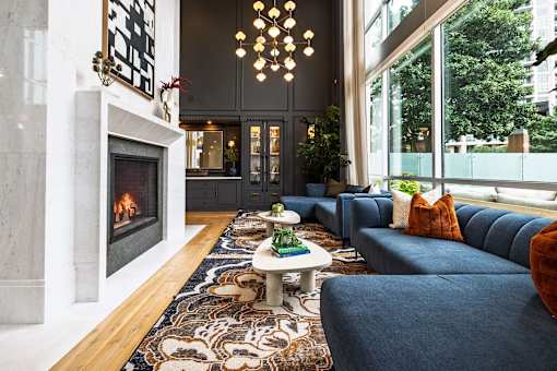 A living room with a fireplace and a blue couch.