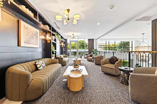 A modern living room with a long sofa and a coffee table.