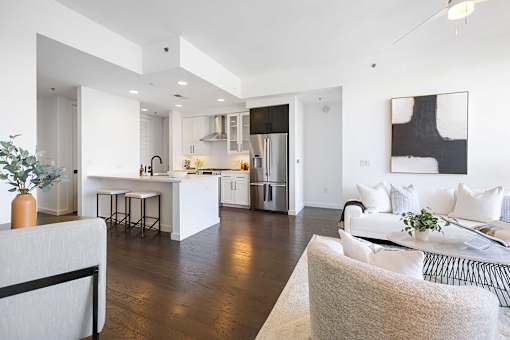 A modern kitchen with white cabinets and a large island.