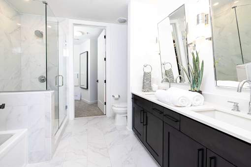 A bathroom with a white toilet and a white sink.