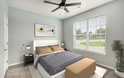 A bedroom with a bed, nightstand, and a ceiling fan.