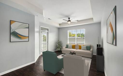A living room with a green chair and a white couch.