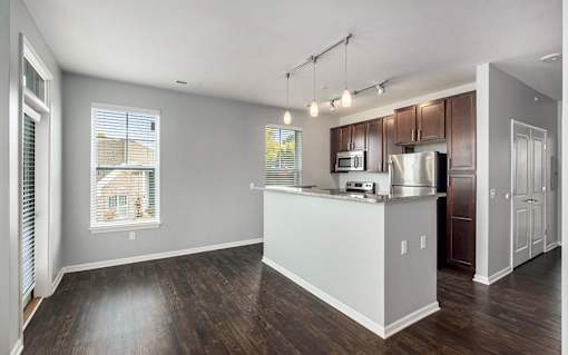 A kitchen with a white counter and brown cabinets.