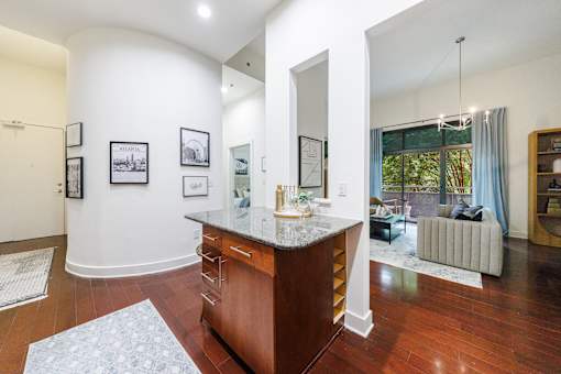 A kitchen with a wooden island and a large mirror on the wall.