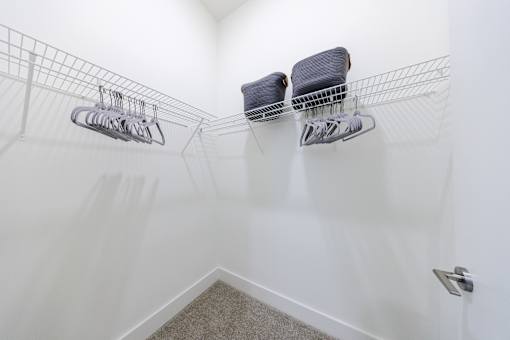 Two shoe racks with shoes on them.