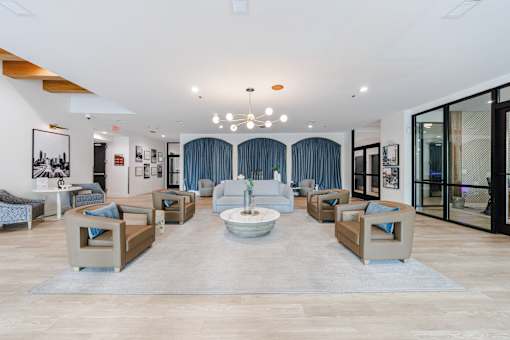 A spacious living room with a large sofa set and a coffee table in the center.
