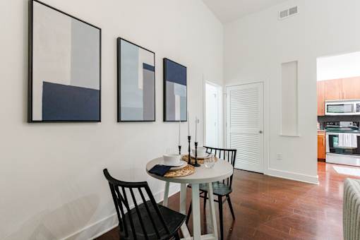 A dining room with a table and chairs.