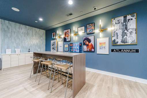 A room with a blue wall and a row of chairs.