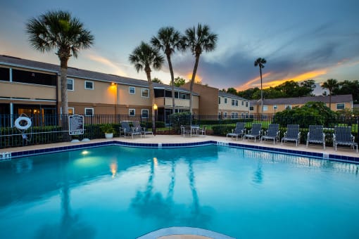 apartments with a large swimming pool at dusk