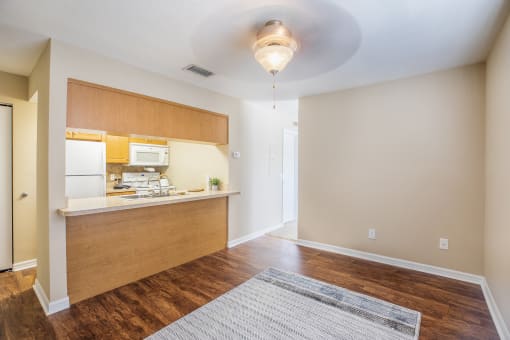 an empty apartment with a kitchen and a living room